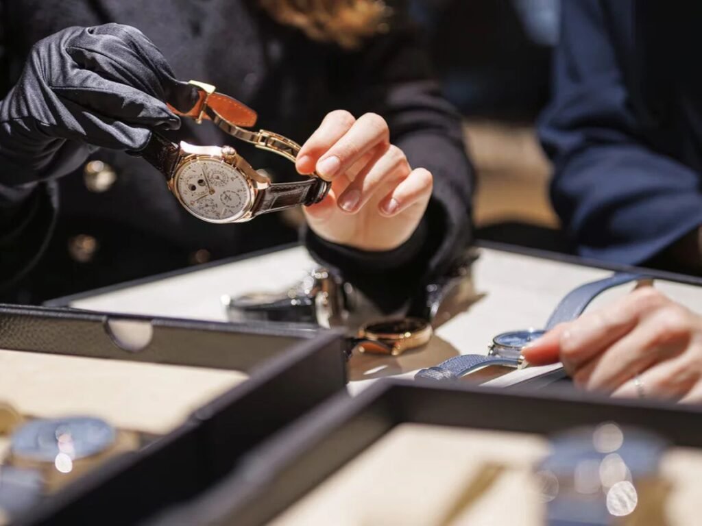 Visitor examining a Patek Philippe luxury watch at Watches and Wonders Geneva 2025.