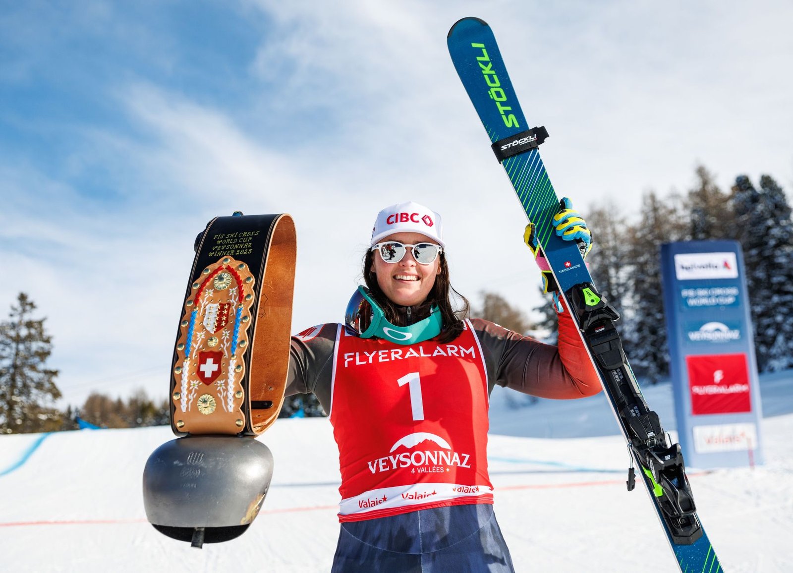 Canadian Olympic skier Marielle Thompson celebrates after winning in Veysonnaz, Switzerland, while holding the traditional Swiss cowbell trophy.