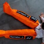 Hyperice x Nike ACG Normatec Elite recovery system in orange.