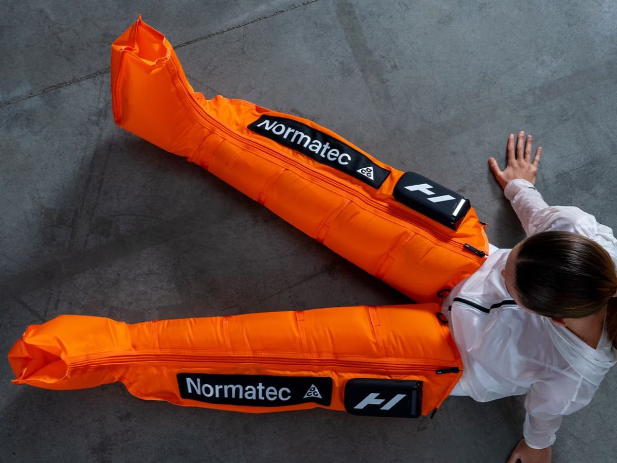 Hyperice x Nike ACG Normatec Elite recovery system in orange.