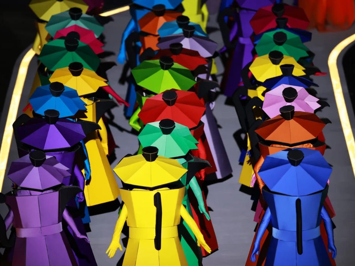 Colourful performers dressed as traditional Italian moka coffee pots at the Milano Cortina 2026 Winter Olympics opening ceremony.