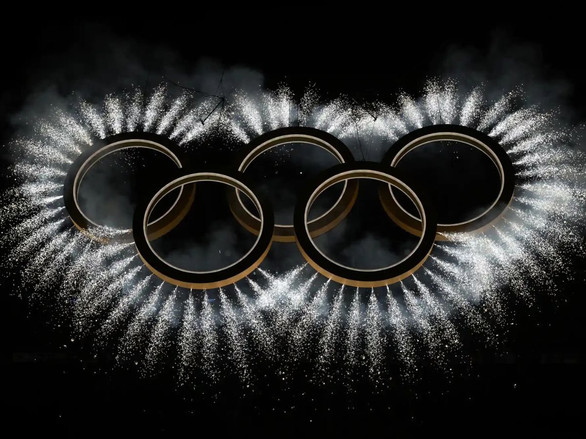 Olympic rings illuminated by fireworks at the Milano Cortina 2026 Winter Olympics opening ceremony.