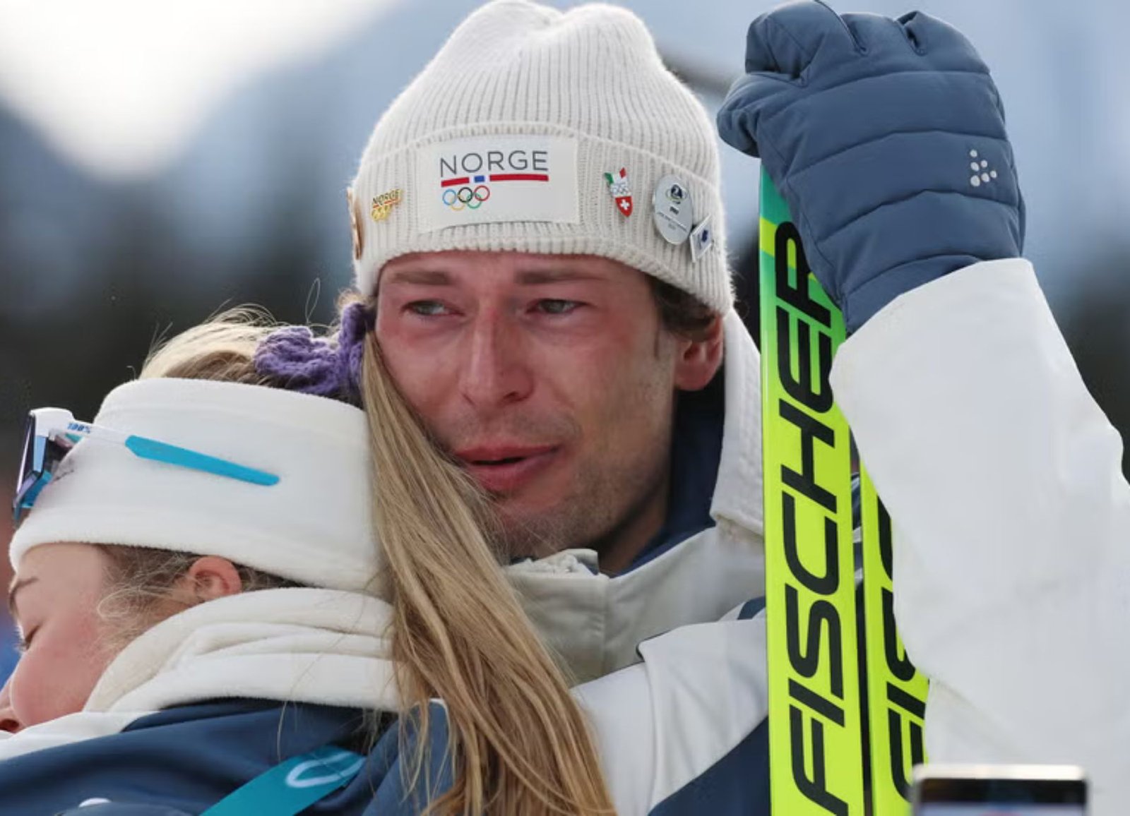 Norway's Sturla Holm Lægreid embraces a teammate after winning bronze in the men's 20 km biathlon at the Olympic Winter Games Milano Cortina 2026.