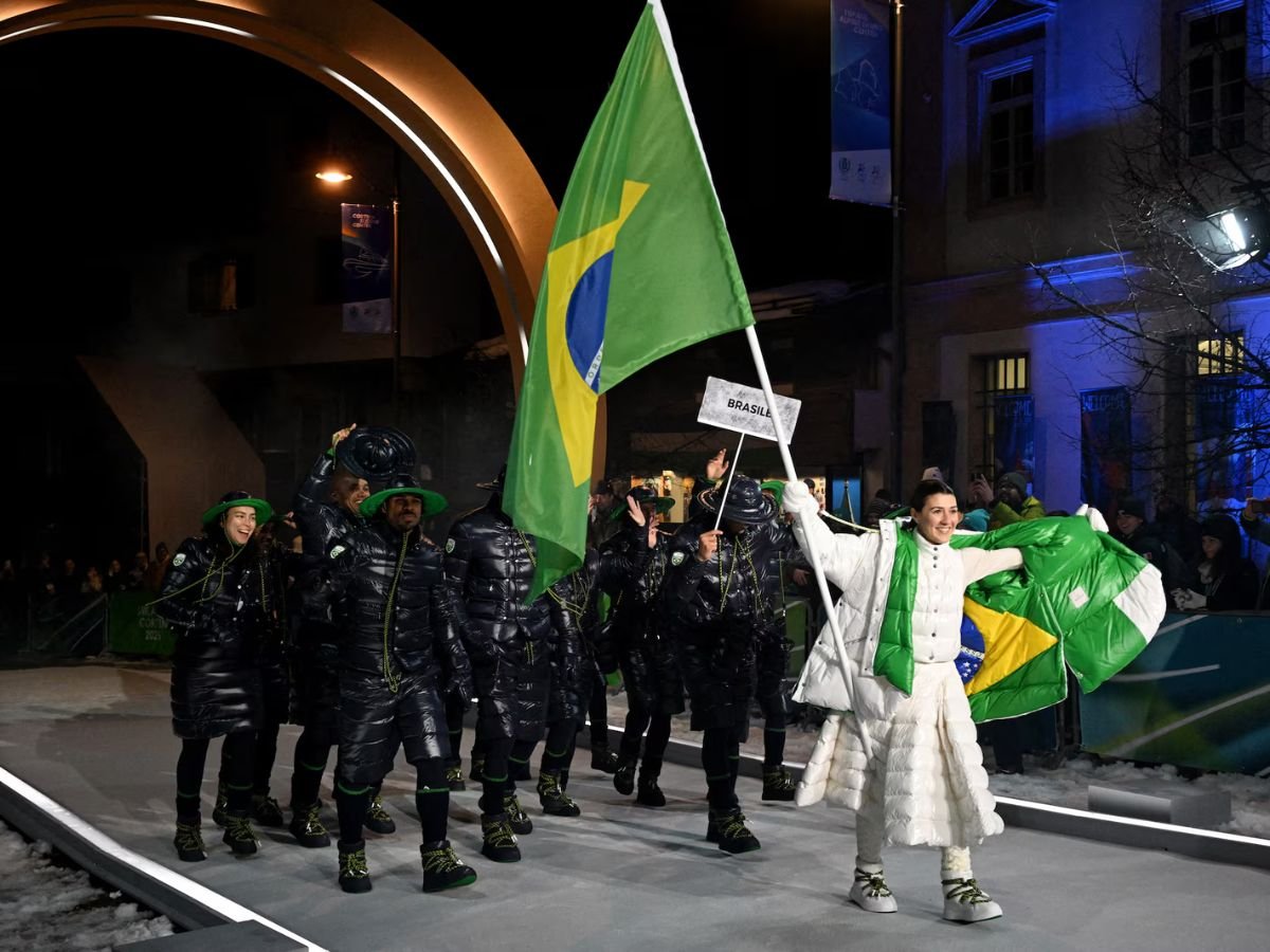 Team Brazil parades during the Milano Cortina 2026 Winter Olympics opening ceremony, with the flag bearer leading the delegation and waving the Brazilian flag.