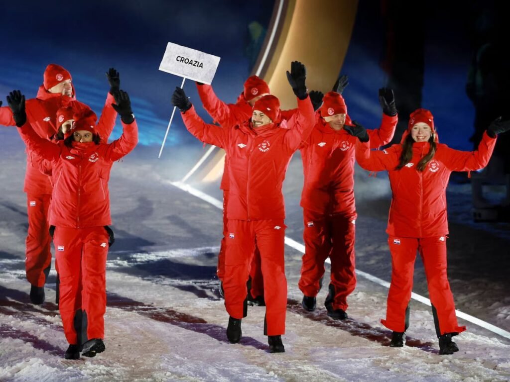 Team Croatia parades at the Milano Cortina 2026 Winter Olympics opening ceremony, with athletes in red uniforms waving to spectators.