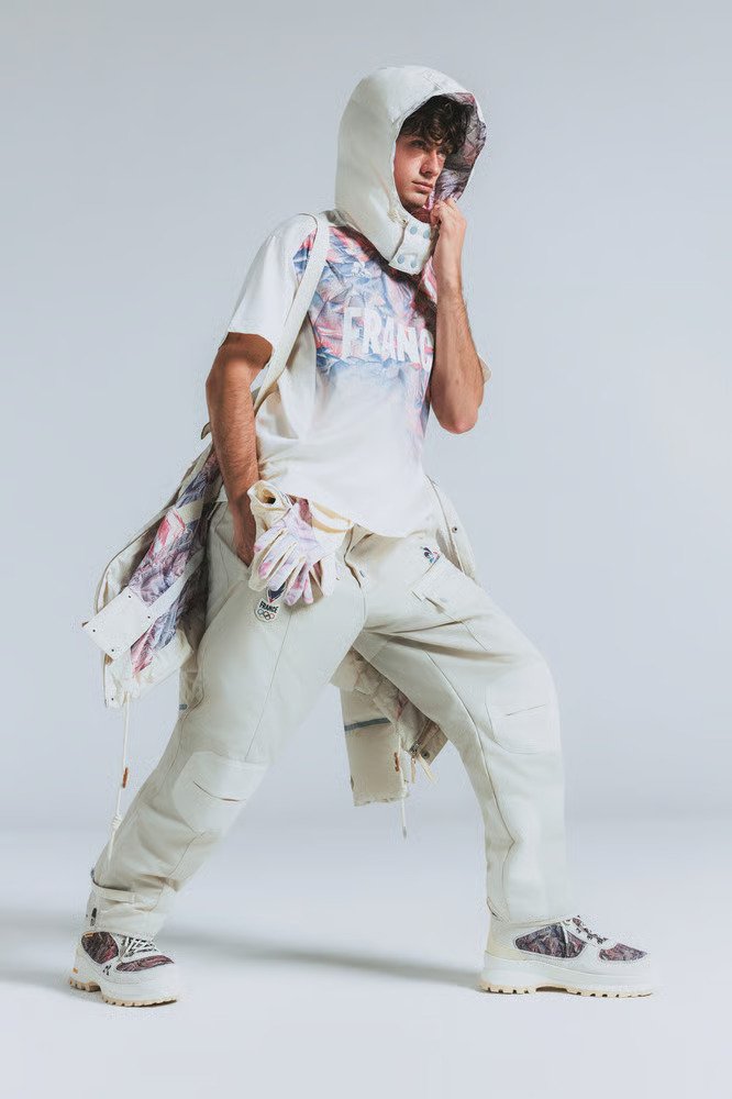 Model wearing the Le Coq Sportif Team France Winter Olympics 2026 uniform, designed by Stéphane Ashpool and featuring alpine-inspired technical sportswear.