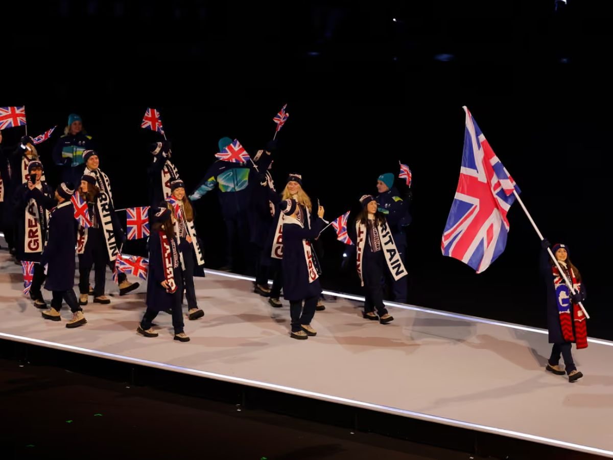 Team Great Britain waves Union Jack flags as the delegation parades at the Milano Cortina 2026 Winter Olympics opening ceremony.