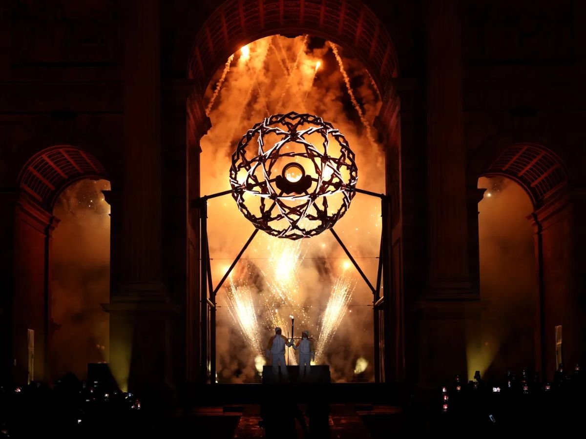 Deborah Compagnoni and Alberto Tomba light the Olympic cauldron at the Milano Cortina 2026 Winter Olympics opening ceremony.