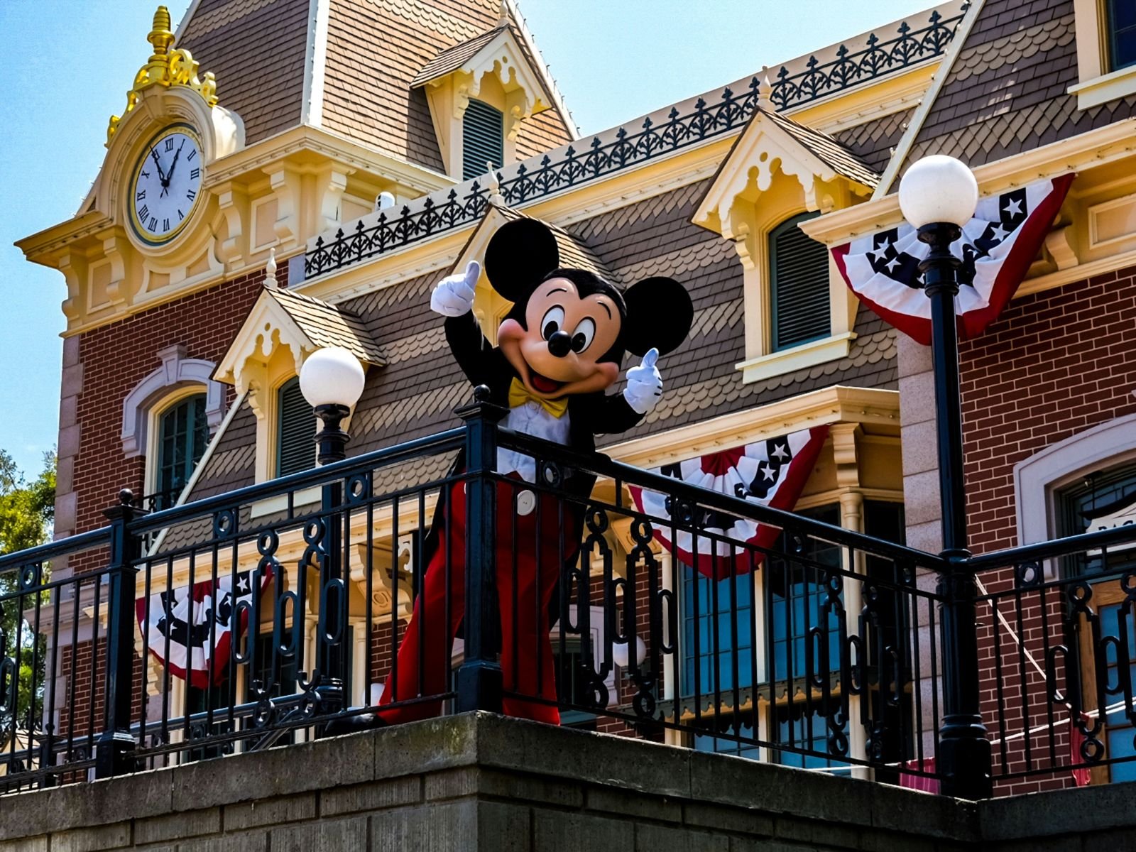 Mickey Mouse welcomes visitors outside the Disneyland Railroad station at Disneyland Park in Anaheim.