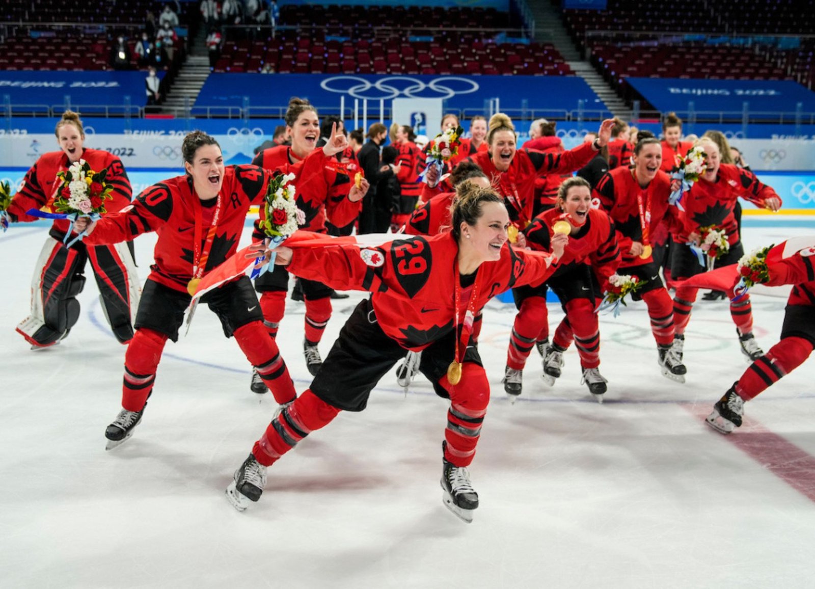 Marie-Philip Poulin and Team Canada celebrate their gold medal win in women's ice hockey at the Beijing 2022 Winter Olympics.