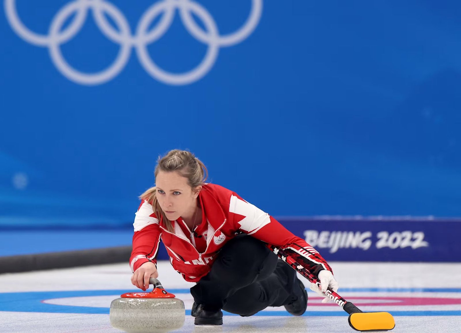 Rachel Homan delivers a stone in a curling match at the Beijing 2022 Winter Olympics.