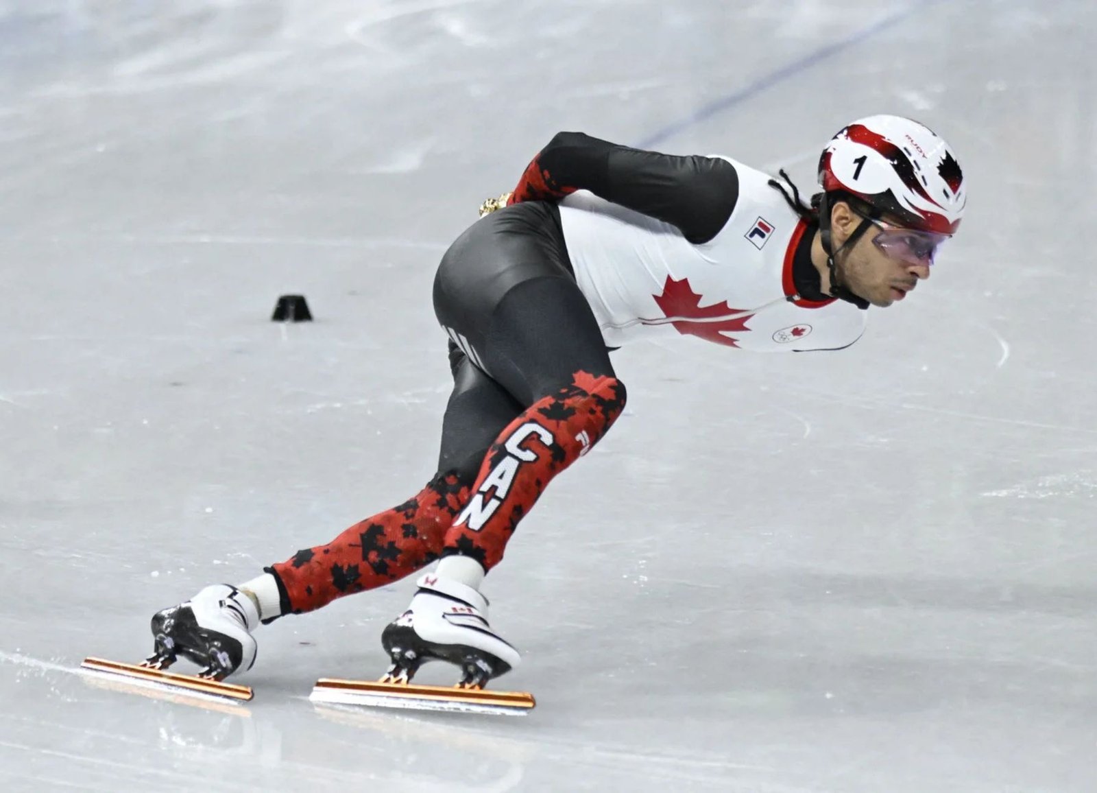 Canada's William Dandjinou competes in the men's 1000m short track speed skating semifinal at the Olympic Winter Games Milano Cortina 2026.