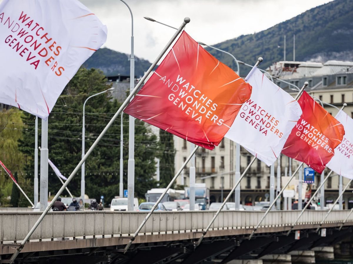 Flags for Watches and Wonders Geneva are displayed across a bridge in Geneva.